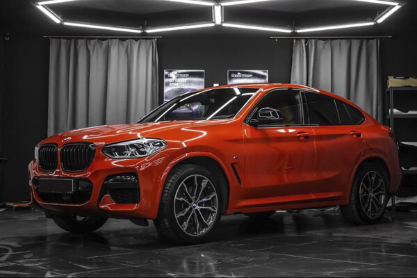 Clear paint protection film on red car