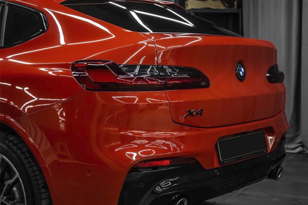 Clear paint protection film on red car