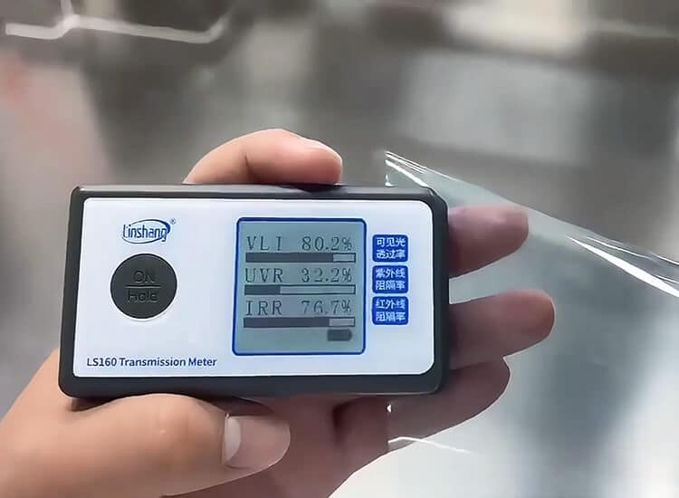Handheld transmission meter demonstration on a film sample Handheld transmission meter measuring a transparent film sample